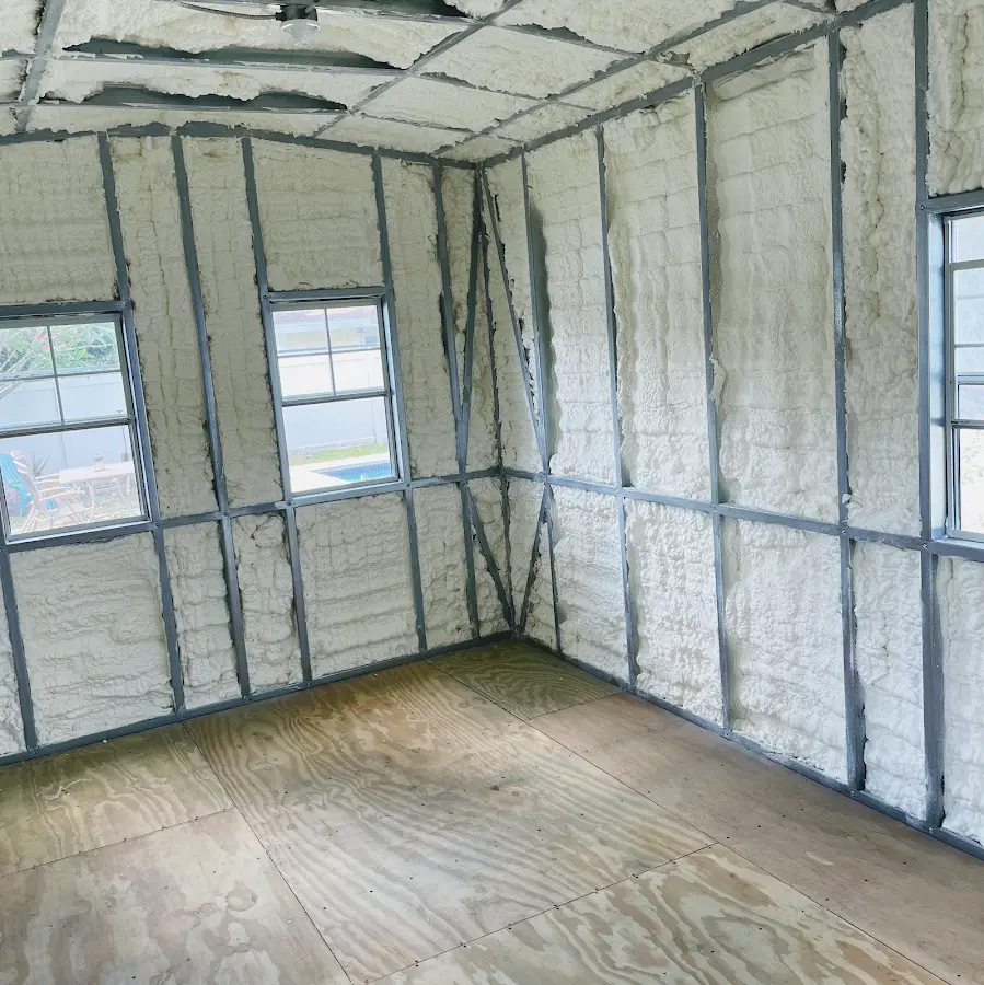 Closed-cell spray foam insulation applied to wall cavities in a residential project in Harrah
